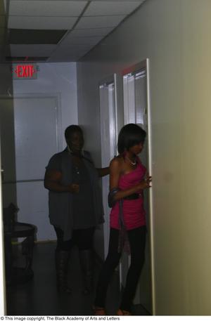[Rachel Webb and woman entering dressing room]