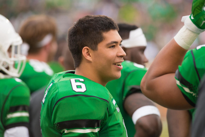 Mason Fine on sidelines with teammates] - UNT Digital Library