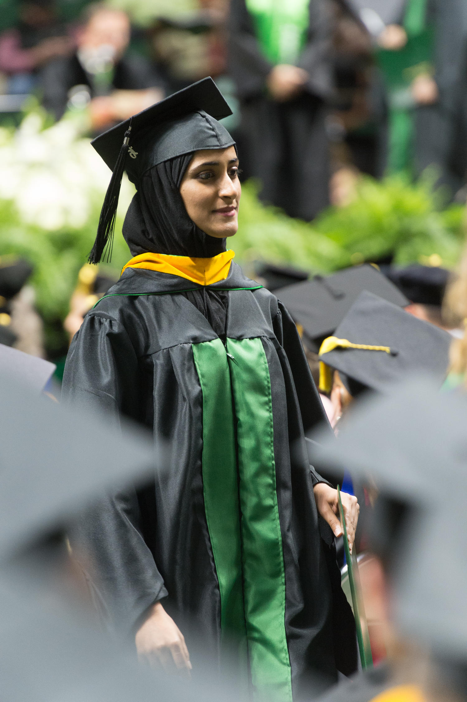 [Graduate Student Walking with her Diploma] UNT Digital Library