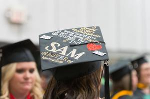 [Journalism Master's Graduate wearing decorated cap]