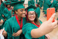 Primary view of [Two Students Taking Selfie At Graduation Ceremony]