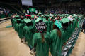 Primary view of [Undergraduate Students at Commencement Ceremony with Decorated Caps]