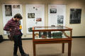 Primary view of [Kevin Yanowski looks at a standing display case]