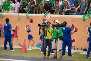 [Photographers on sidelines of UNT Homecoming game]