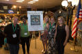 Photograph: [Mayborn Magazine team standing by poster of cover-page]