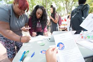 [Students registering to vote at the UNT Library Mall]
