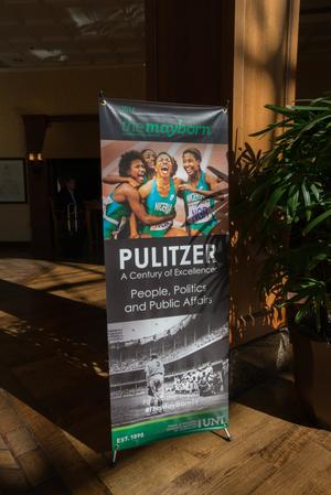 [Promotional standing banner at conference]