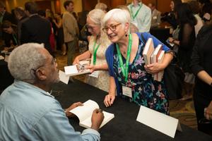 Primary view of object titled '[Attendee having book signed]'.
