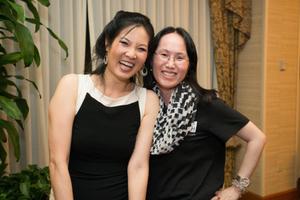 Primary view of [Sheryl WuDunn standing with a conference attendee]