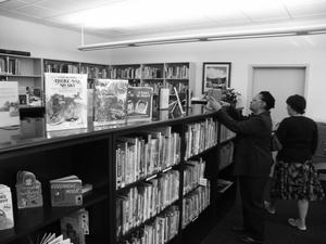 [Two women looking at books in the Good Samaritan library]