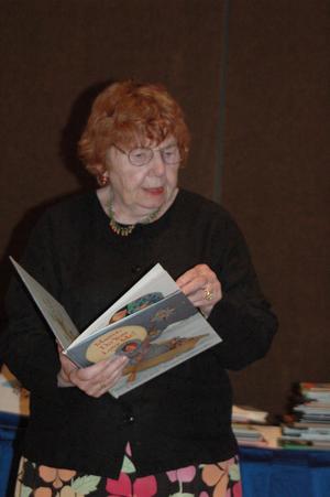 [Woman reading children's book at CSLA conference]