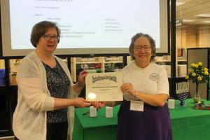 [Susan Snyder accepting recognition certificate]