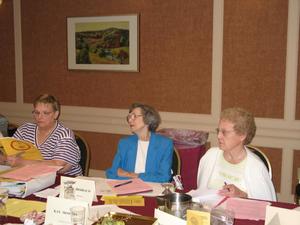 [Board members reviewing documents at CSLA conference]