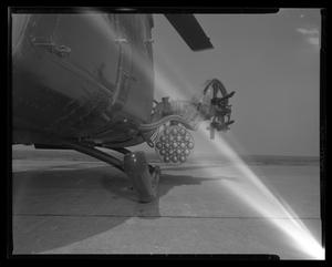 [Photograph of a side view of a UH-1B Iroquois helicopter with a loaded rocket pod]