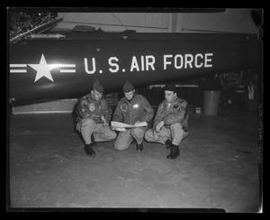 [Photograph of three individuals posing in front of a UH-1F Iroquois helicopter, 2]