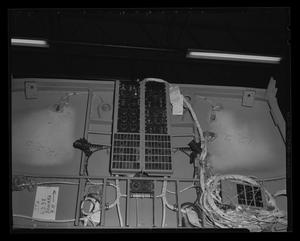 [Photograph of wiring and a control board inside a UH-1B Iroquois helicopter]