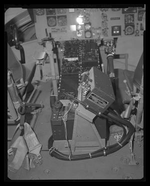 [Photograph of controls between the seats of a UH-1B Iroquois helicopter cockpit]