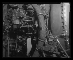 [Photograph of mechanical components inside a UH-1B Iroquois helicopter]