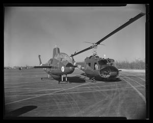 [Photograph of the UH-1B Iroquois helicopter next to the "Iroquois Warrior" aircraft]