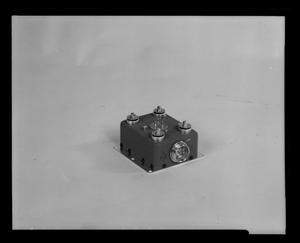 [Photograph of a small electrical component for a UH-1B Iroquois helicopter]