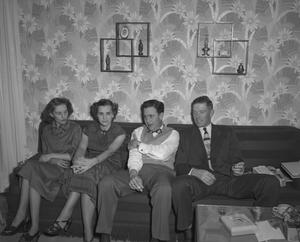 [Two men and two women on a couch]