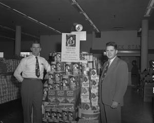 [Two Men Posing with a Store Display]
