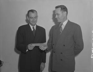 [Two Men Holding a Paper Slip]