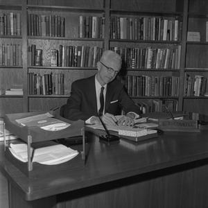 [Dr. L.F. Connell at his desk, 8]