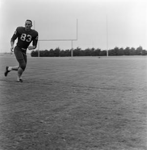 [Football player running on the field, 4]
