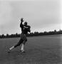Photograph: [Football player running with an outstretched arm, 2]