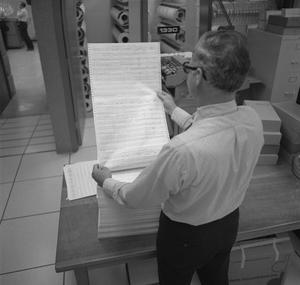 [Man reading a report, 4]