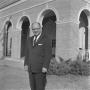 Photograph: [Dr. Kenneth Cuthbert in front of Bruce Hall, 2]