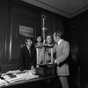 [The debate team and their first place trophy #9]