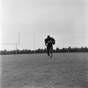 [Football player running on the field, 3]