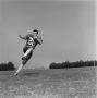 Photograph: [Football player running with an outstretched arm, 9]