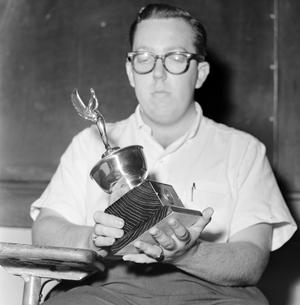 [A debate club member holding a trophy #2]