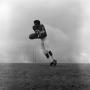 Photograph: [Football player falling with a ball]
