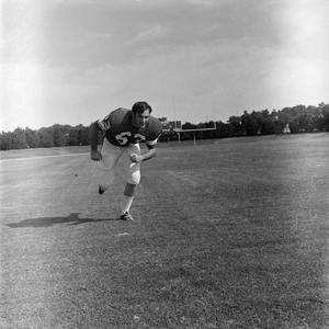 [Football player #63, Robert Snead, running with his shoulders forward toward the camera, 2]