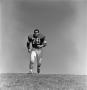 Photograph: [Football player #79, Louis Roche, jogging during practice]
