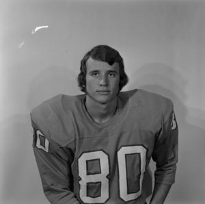 [Football player sitting for a portrait, 13]