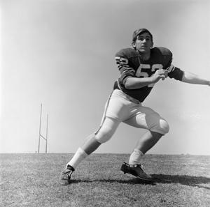 [Football player #52, Jerry Robinson, changing directions at a run]