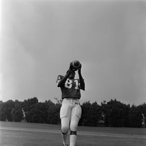 [Football player #81 from the 1971 season catching an football with his feet cropped out of frame]