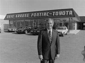 [Man standing in front of a Pontiac-Toyota dealership, 6]