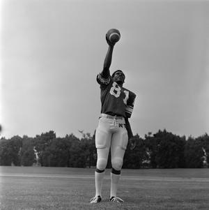 [Football player #81 from the 1971 season catching a football in his raised right hand]
