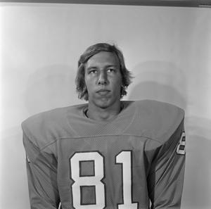 [Football player sitting for a portrait, 17]