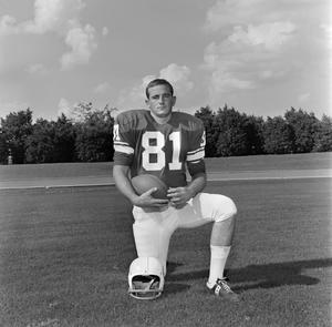 [Football player number 81 posing in a football field, 3]