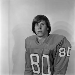 [Football player sitting for a portrait]
