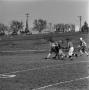 Photograph: [Football players tackling an opponent, 7]
