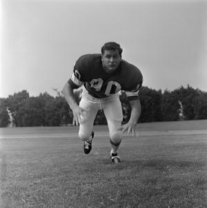 [Football player #90 from the 1971 season charging the camera]