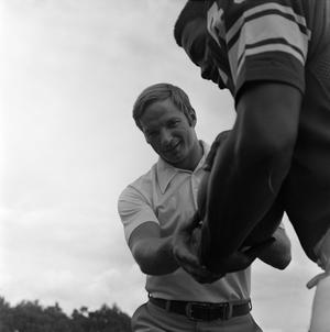 [Football coach standing with a player, 3]